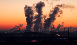 Image: coal plant emitting smoke Topic: Environmental Justice, fossil fuels, and telecoms